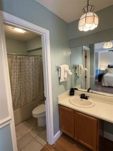 a bathroom with a sink and a toilet and a mirror at Rivers Edge 802 in Helen +14 photos