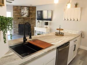 a kitchen with a sink and a fireplace at Rivers Edge 703c in Helen +8 photos
