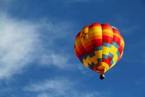 a colorful hot air balloon flying in the sky at Bavarian Brook Unit 6A in Helen
