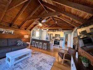 a living room with a couch and a kitchen at Bavarian Brook Condo 14 in Helen +2 photos