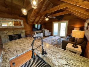 a kitchen and living room in a log cabin at Bavarian Brook Condo 14 in Helen