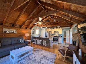 a living room with a couch and a kitchen at Bavarian Brook Condo 14 in Helen