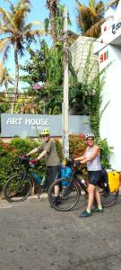 two people standing with their bikes in front of an art house at Art House in Dickwella