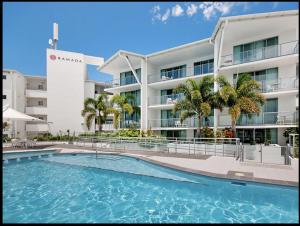 a swimming pool in front of a building at Water Front Retreat Ballina in Ballina