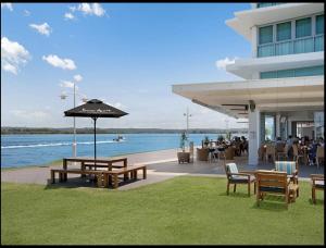 a building with tables and chairs and an umbrella at Water Front Retreat Ballina in Ballina