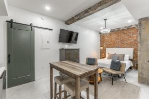 a bedroom with a bed and a table with chairs at Park Hotel Studio Suite 303 in Chattanooga