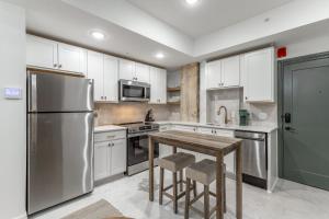 a kitchen with a stainless steel refrigerator and a wooden table at Park Hotel Studio Suite 303 in Chattanooga +22 photos