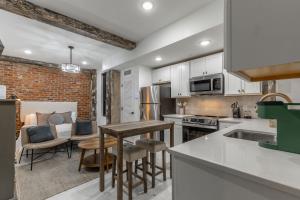 a kitchen with white cabinets and a table and chairs at Park Hotel Studio Suite 303 in Chattanooga