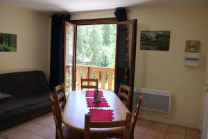 a dining room with a table and a window at Les faons in Roubion