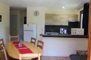 a kitchen with a table with a cake on it at Les faons in Roubion +5 photos
