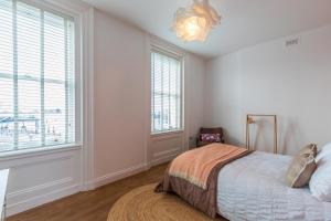 a bedroom with a bed and a large window at Harbour-View Apartment Facing HMS Warrior in Portsmouth