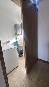 an open door to a kitchen with a refrigerator at Residencia con alberca in Las Ánimas +18 photos