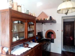 a kitchen with a wooden cabinet with dishes in it at Affitta camere Explora caffè in Trieste
