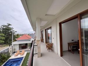 a balcony of a house with a swimming pool at Paramulia house in Canggu