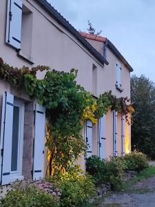 a white house with a bunch of windows at L'Orée du Puy in Les Herbiers