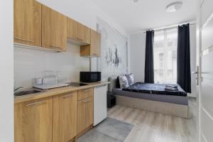 a small kitchen with a bed in a room at 70s Business Room in Krakow +71 photos
