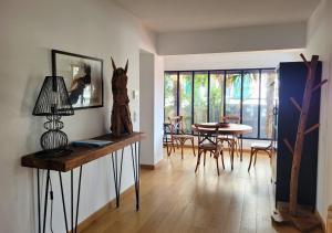 a living room with a table and a dining room at G-63 - Appartement de standing en plein coeur d'Hossegor in Soorts-Hossegor