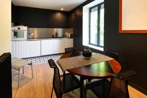 a kitchen and dining room with a table and chairs at Maison Valmer - L'armateur, élégant penthouse classé 4 étoiles in Le Havre