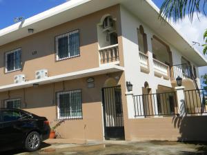 a building with a car parked in front of it at Pedro Villas in Tamuning