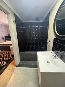 a bathroom with a sink and a shower at Little West in Margate +30 photos