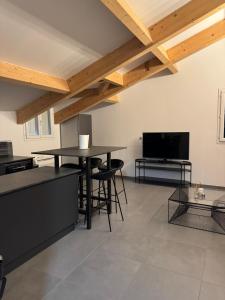 a living room with two tables and a flat screen tv at Casa di a Volpe in Corte