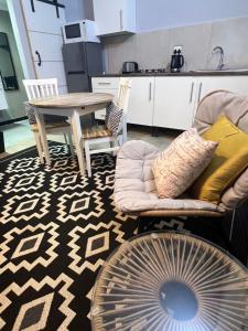 a living room with a table and two chairs at Little West in Margate