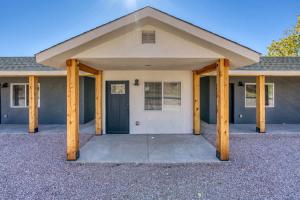 a house with wooden pillars in front of it at Red Rock Views Tiny Suite Kanab Basecamp in Kanab
