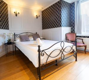 a bedroom with a bed and two chairs at Hostel Lybeer Private Rooms just for two! in Bruges