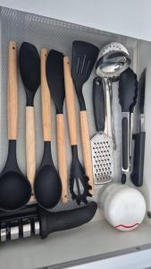 a drawer filled with lots of cooking utensils at Brisas do Lago II in Paulo Afonso