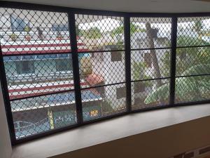a view through a window of a cage at Dwaraka Serviced Villa - Near Sree Padmanabha Swamy Temple, Trivandrum -AC Rooms & Parking in Trivandrum