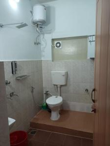 a bathroom with a white toilet and a shower at Dwaraka Serviced Villa - Near Sree Padmanabha Swamy Temple, Trivandrum -AC Rooms & Parking in Trivandrum +8 photos