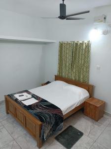 a bedroom with a bed with a white sheets and a window at Dwaraka Serviced Villa - Near Sree Padmanabha Swamy Temple, Trivandrum -AC Rooms & Parking in Trivandrum
