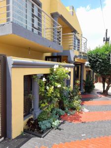 a building with flowers on the side of it at THE ROSE BnB in Soweto