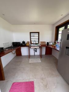 a room with a kitchen with a sink and a refrigerator at MOOREA CHILL and BEACH LODGE in Teavaro +22 photos