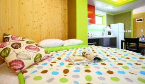 a bedroom with a bed with a book on it at Pinky Marine Pension in Namhae