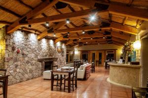 a restaurant with a stone wall and a fireplace at La Comarca Hotel in Purmamarca