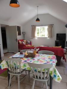 a living room with a table and chairs at Stable Cottage at Hanley Mill in Tenbury