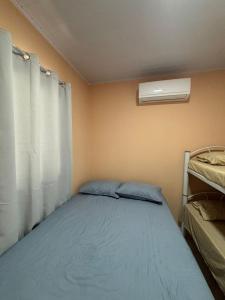 a small bedroom with a bed and a window at pousada Bela Rosa in Santa Cruz Cabrália +26 photos