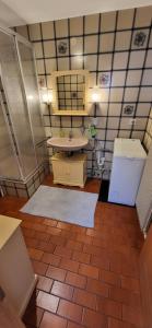 a bathroom with a sink and a toilet in it at Ferienwohnung Vogelsang in Sachsenheim +21 photos
