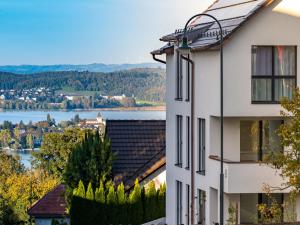 a white building with a view of a lake at Arenenberg-Panorama in Salenstein