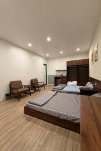 a large bedroom with two beds in a room at Phoenix home in Phù Ninh