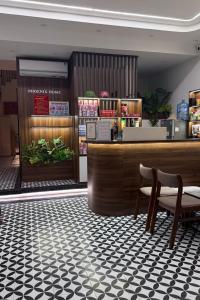 a restaurant with a counter and chairs in a room at Phoenix home in Phù Ninh +20 photos