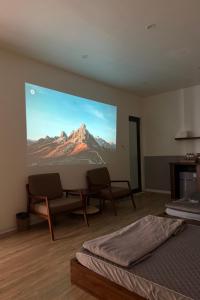 a room with two beds and a projection screen at Phoenix home in Phù Ninh