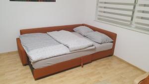 a bed with two pillows on it in a room at Happy Corner in Varaždin