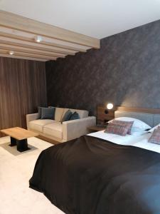 a living room with a bed and a couch at WOODSIDE SPA AND PARKING 323 Kopaonik011 in Kopaonik