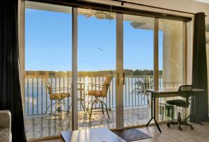 a room with a balcony with sliding glass doors at Sunsets Waterview Balcony King Bed & Heated Pool in St. Petersburg