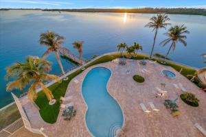 an aerial view of a resort swimming pool with palm trees at Sunsets Waterview Balcony King Bed & Heated Pool in St. Petersburg