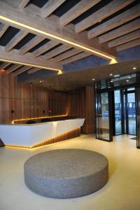 a lobby with a reception desk and a circular rug at WOODSIDE SPA AND PARKING 323 Kopaonik011 in Kopaonik