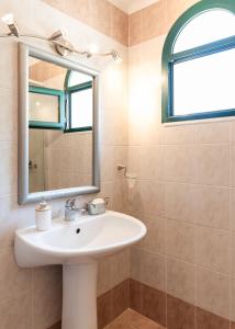 a bathroom with a sink and a mirror at Joya Luxury Villas in Kypseli +46 photos