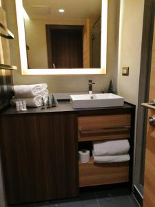 a bathroom with a sink and a mirror at WOODSIDE SPA AND PARKING 323 Kopaonik011 in Kopaonik